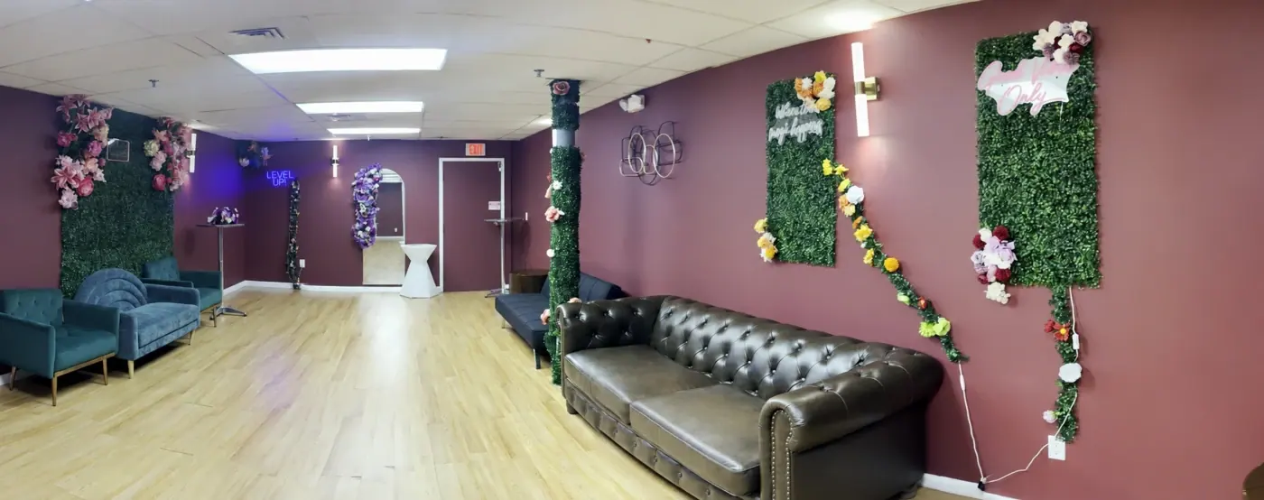 Legacy Events CT lounge with sofas, floral walls, and an open seating area